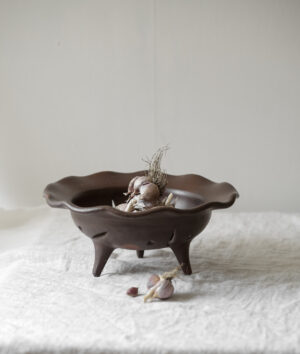 Three-legged stoneware bowl